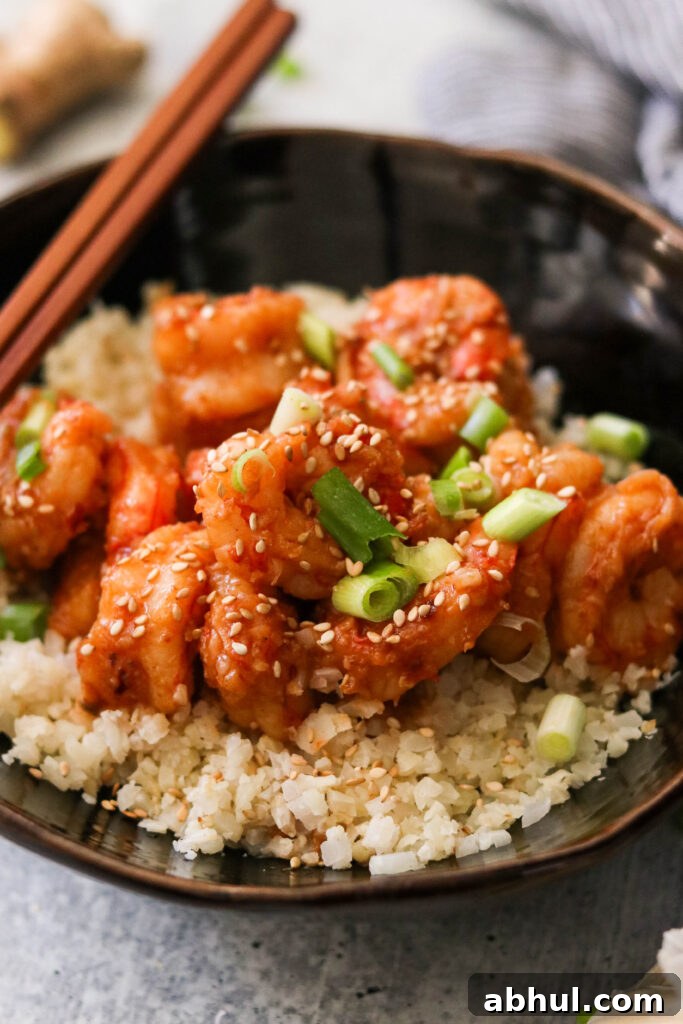 Whole30 chili garlic shrimp topped with sesame seeds and green onions