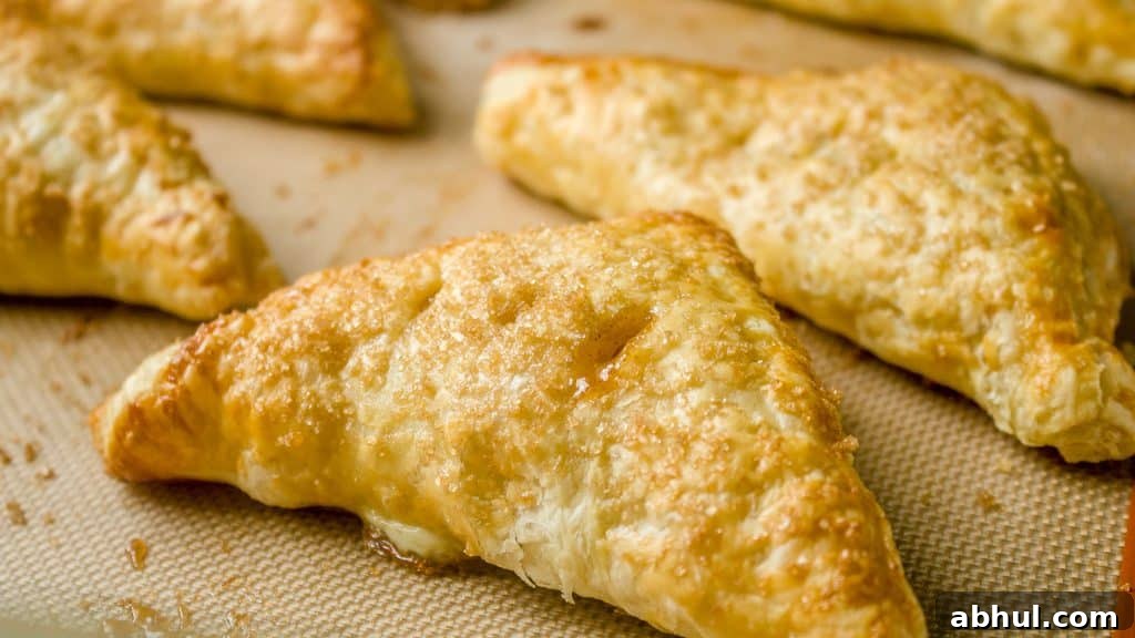 Closeup of peach turnovers on the baking sheet