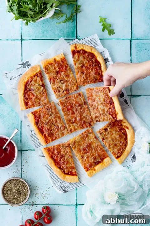 Sliced pizza on baking paper