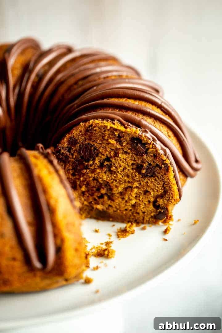 a bundt cake on a cake stand with a slice cut out