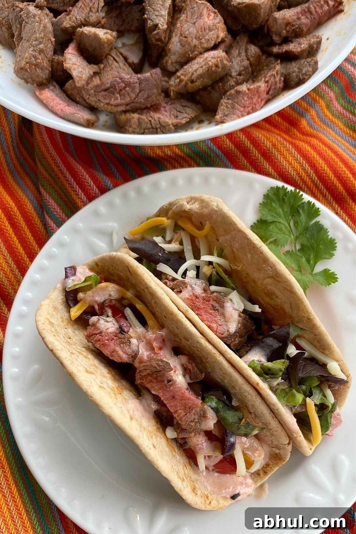 2 Beef Fajitas in low-carb flour tortillas on a plate.
