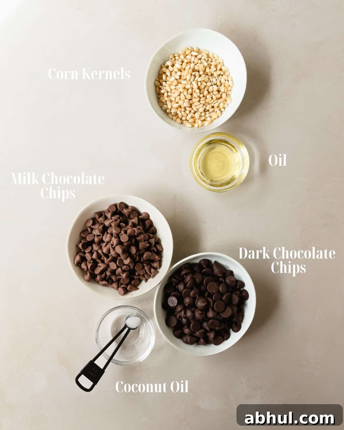Gather white or yellow popcorn kernels, oil, your preferred milk, dark or white chocolate and coconut oil (if you like). If you’d like to top the chocolate popcorn with nuts, candy or coconut flakes, make sure to grab those too. 