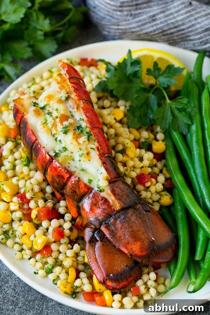 Grilled lobster tail served with couscous and green beans.