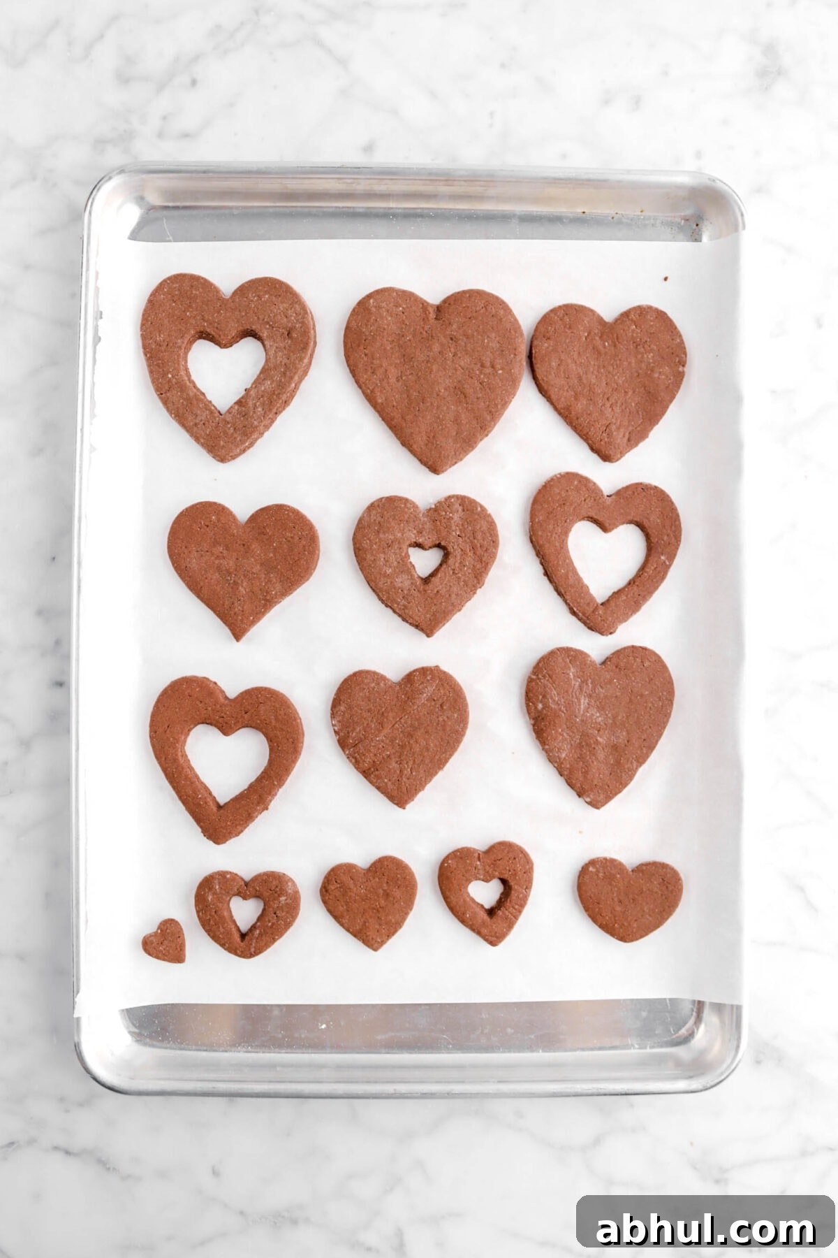 Chocolate-Strawberry Linzer Cookie Recipe for Perfect Sandwich Cookies 23 baked chocolate hearts on sheet pan