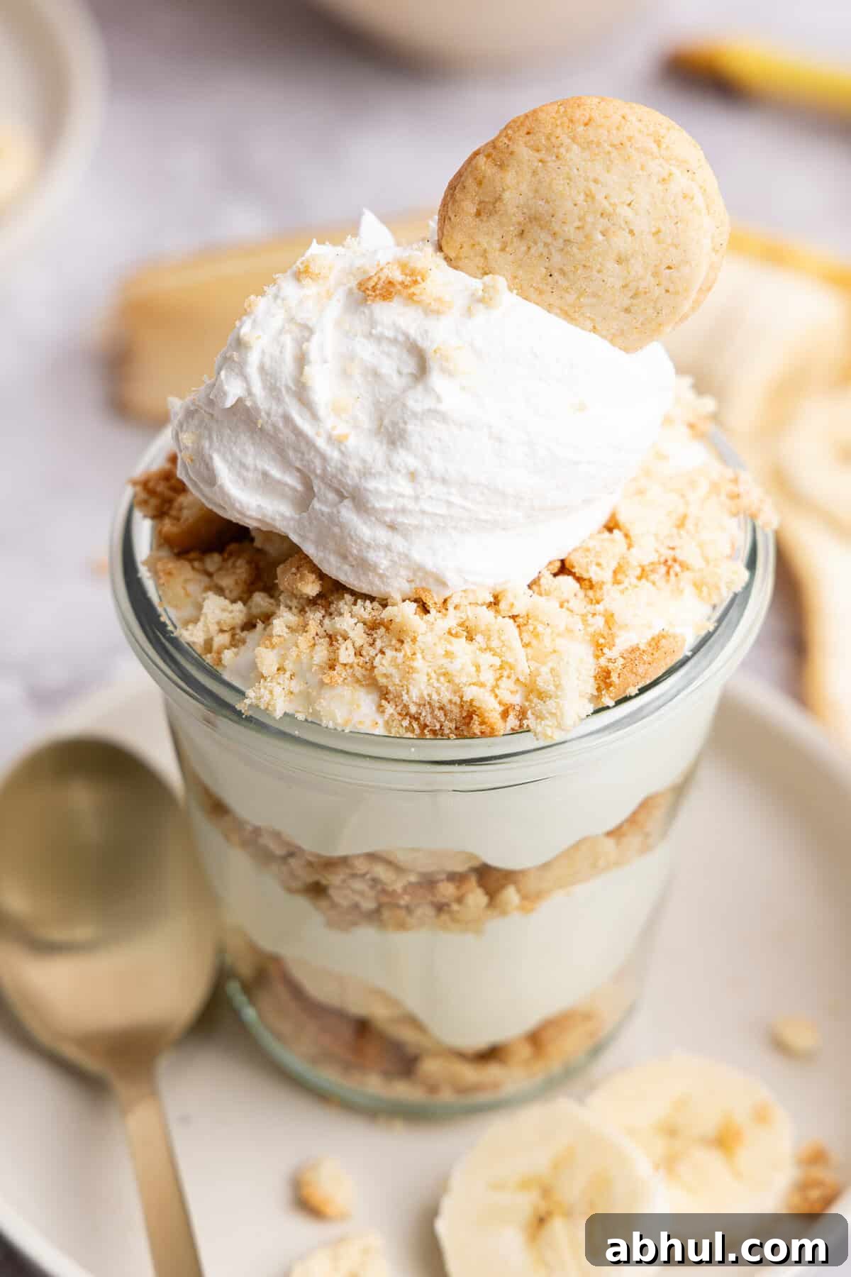 a close up side view of a glass cup of banana pudding