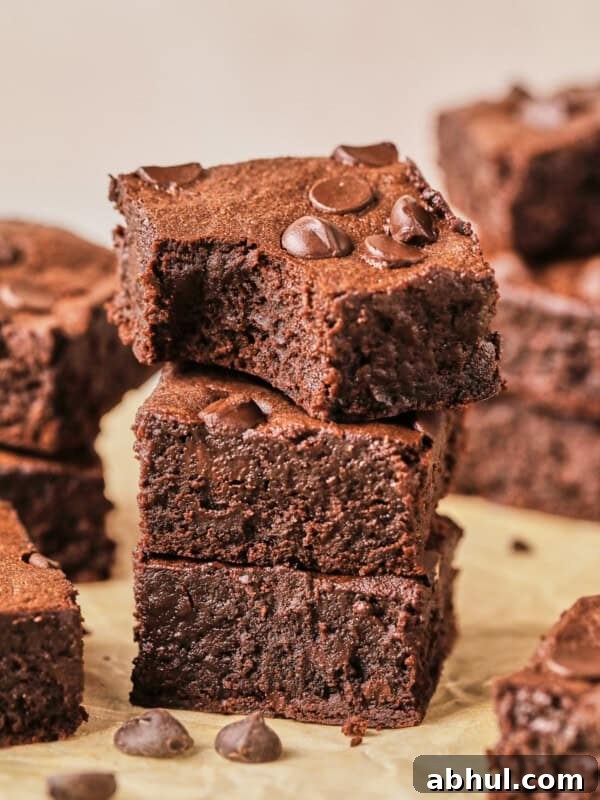protein brownies stacked up on parchment paper