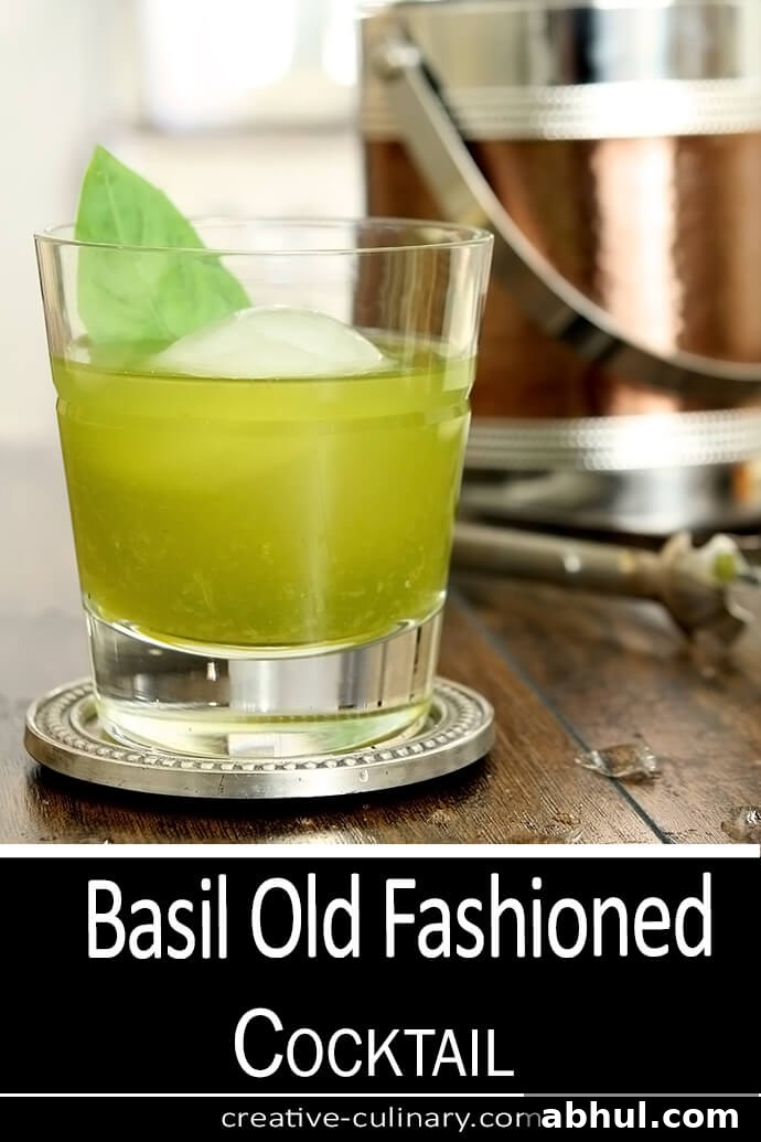 Basil Old Fashioned Cocktail in a lowball glass with a large round ice cube