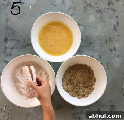 Coating the fish in the flour.