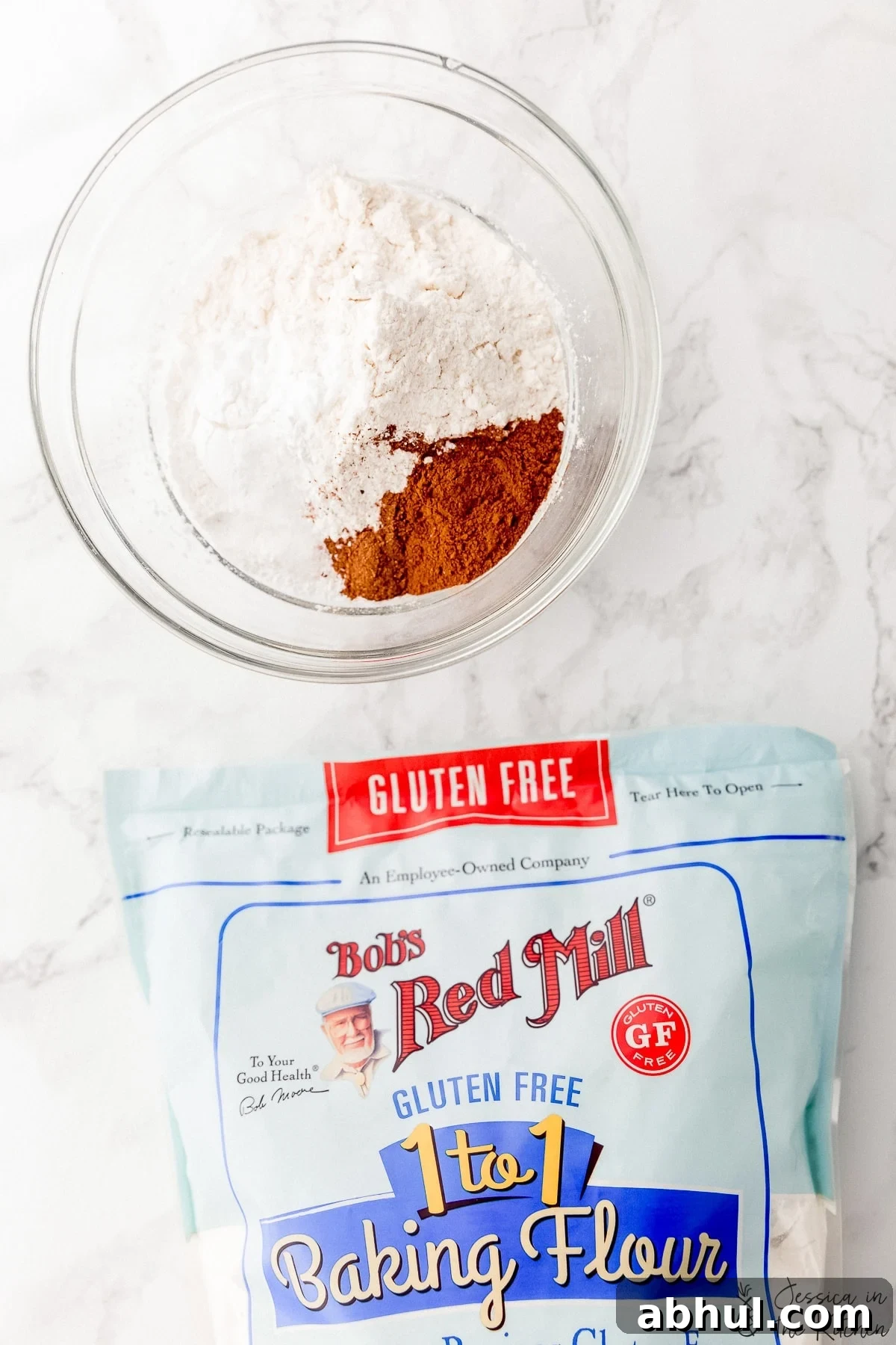 Dry ingredients for a muffin recipe with a bag of Bob's Red Mill Baking Flour birds eye view.