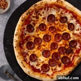 Sourdough pizza dough topped with pepperoni and cheese