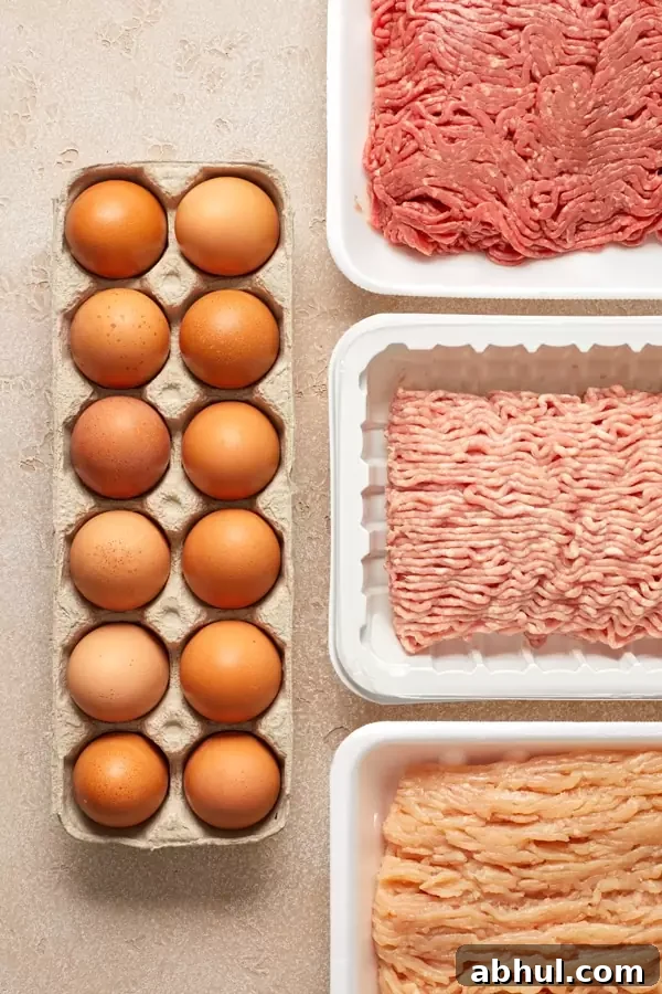 Eggs and ground meats on a surface.