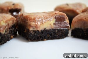 Chocolate Swirl Caramel Fudge Bars are a sweet, gooey, sticky, soft caramel fudge with caramel chocolate (Rolos) mixed throughout the warm caramel to create a swirl on top of an Oreo base. #oreofudge #caramelfudge #caramelchocolatefudge 