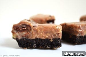 Chocolate Swirl Caramel Fudge Bars are a sweet, gooey, sticky, soft caramel fudge with caramel chocolate (Rolos) mixed throughout the warm caramel to create a swirl on top of an Oreo base. #oreofudge #caramelfudge #caramelchocolatefudge 