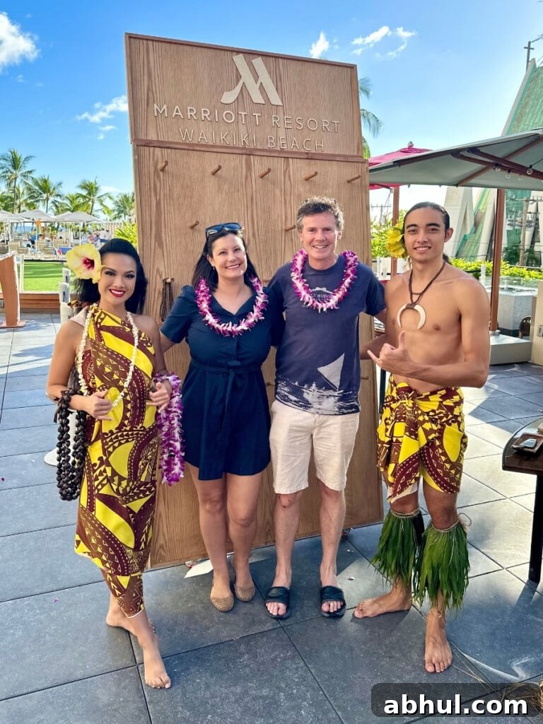 Ashlee and Darragh being welcomed to the Pāʻina Lūʻau Waikiki at the Waikiki Beach Marriott.