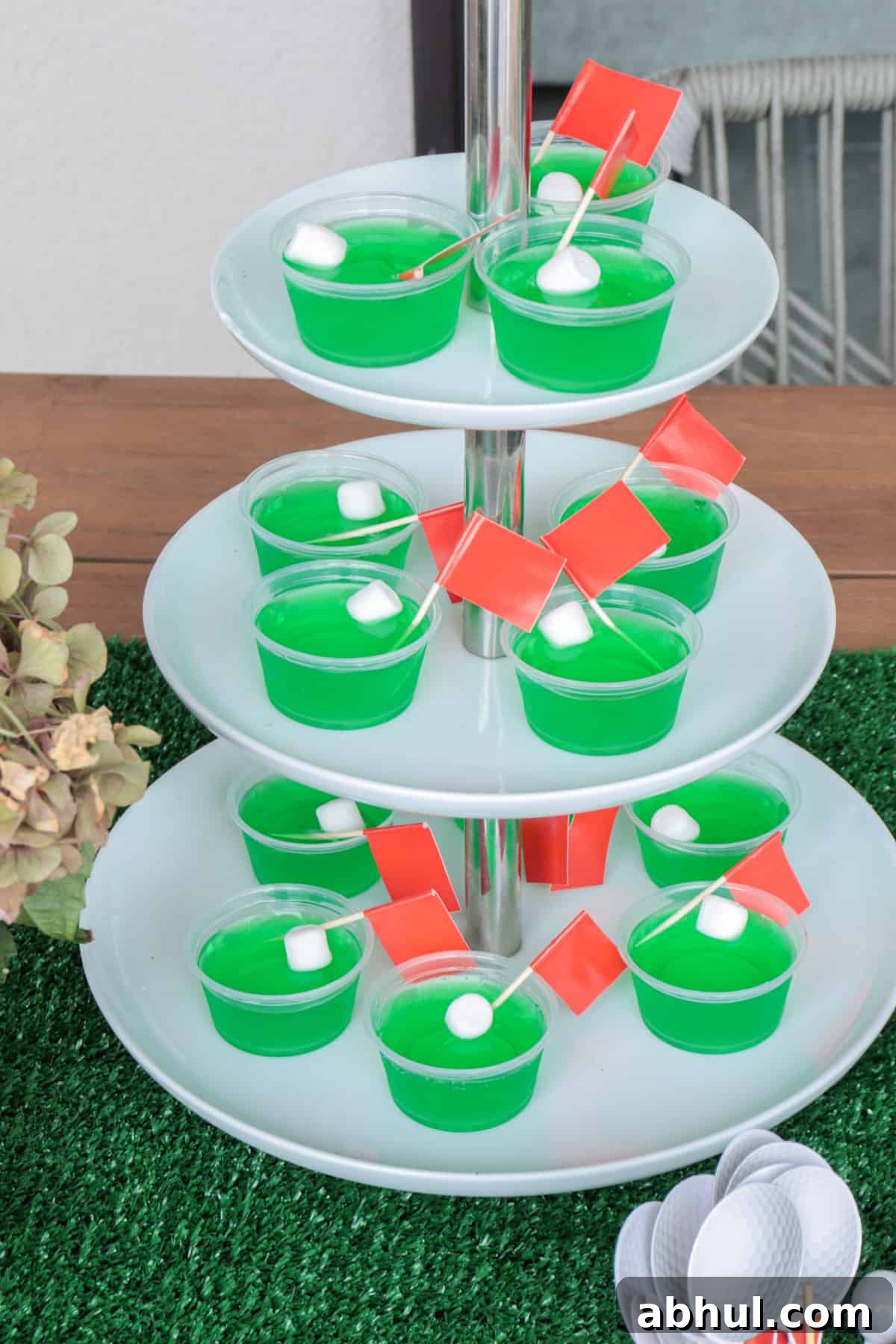Green Jello shots with red flags and white marshmallow ball.
