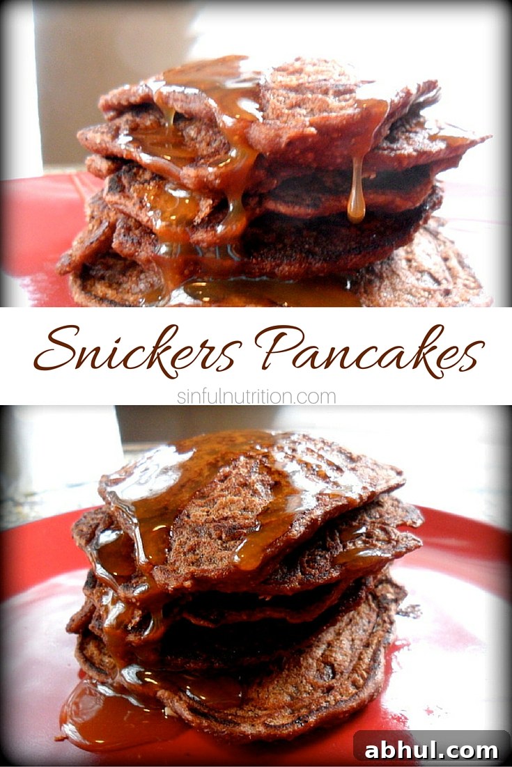 Snickers Pancakes Recipe -- It's like having a candy bar for breakfast! Chocolate Pancakes with crushed peanuts and caramel drizzle.