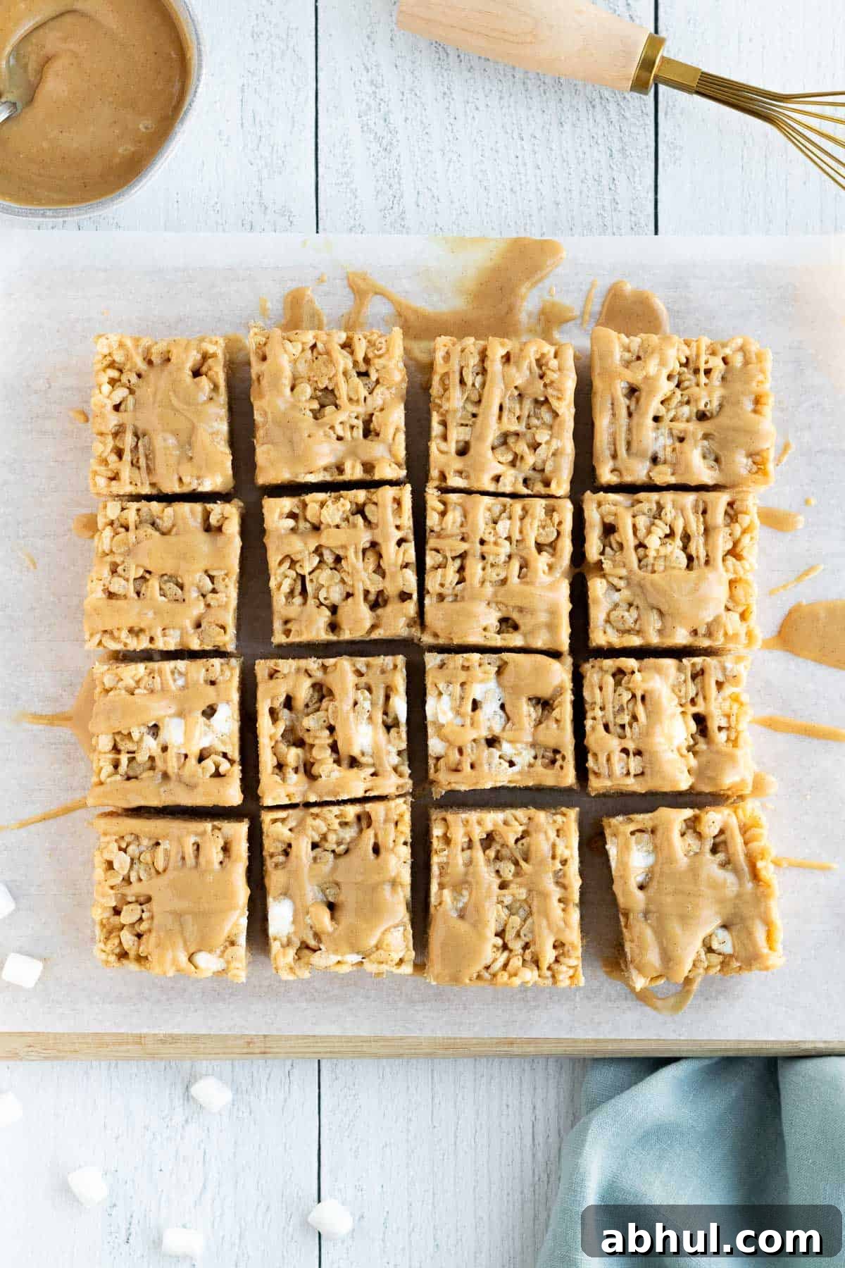 peanut butter rice krispie bars sliced into squares and sitting on a cutting board