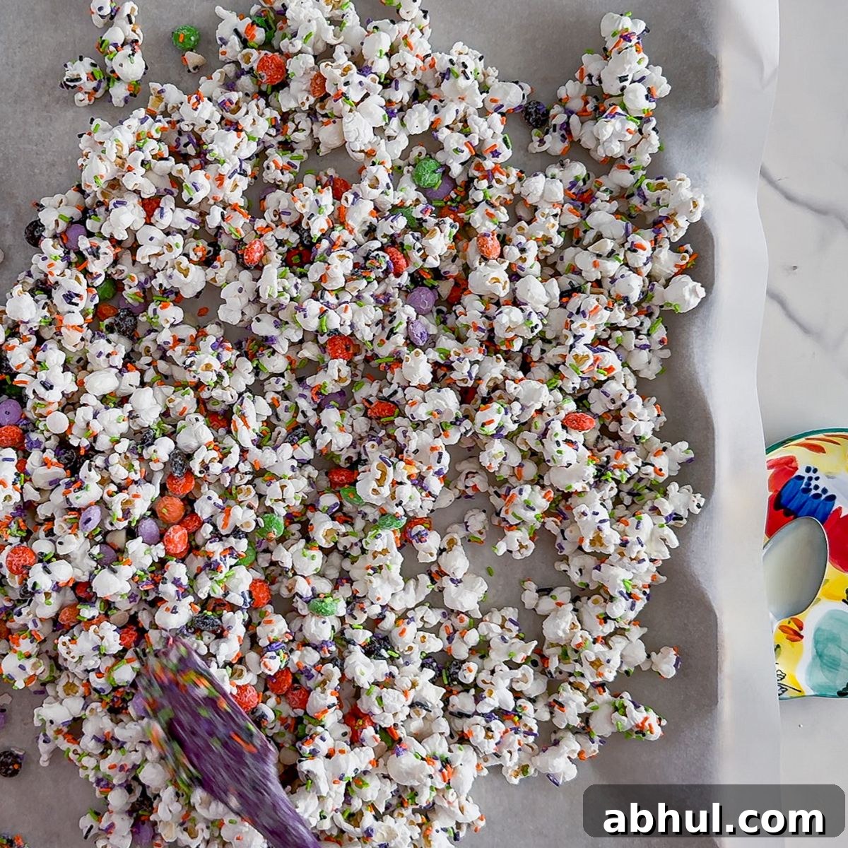 Mixing the halloween popcorn.