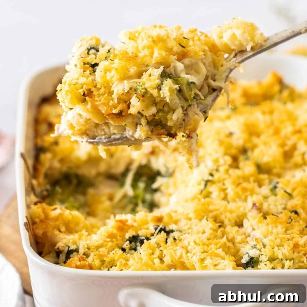 Dish of pasta, with a spoon scooping out a serve.