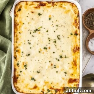 White rectangular dish of Mediterranean Sausage Pasta Bake, topped with a sprinkling of fresh parsley.