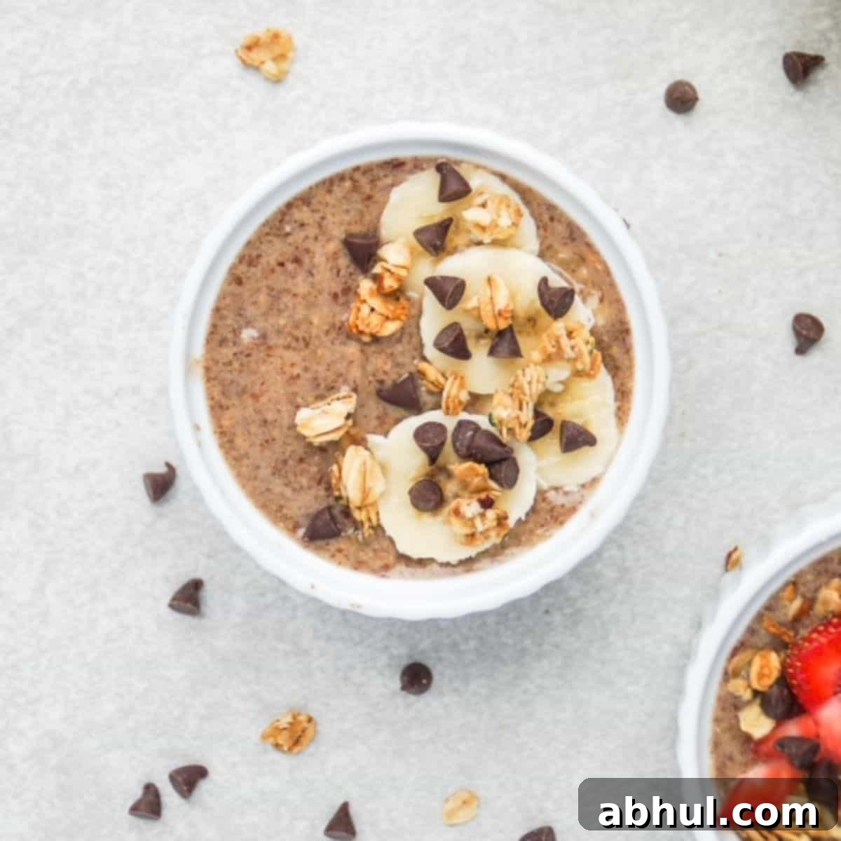 One serving of flaxseed pudding topped with banana slices, granola, and mini chocolate chips.