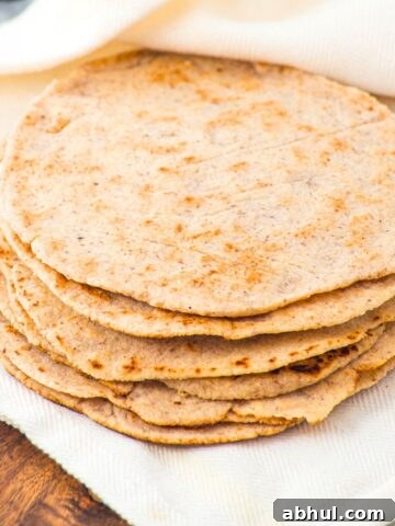 A stack of almond flour tortillas on kitchen towel