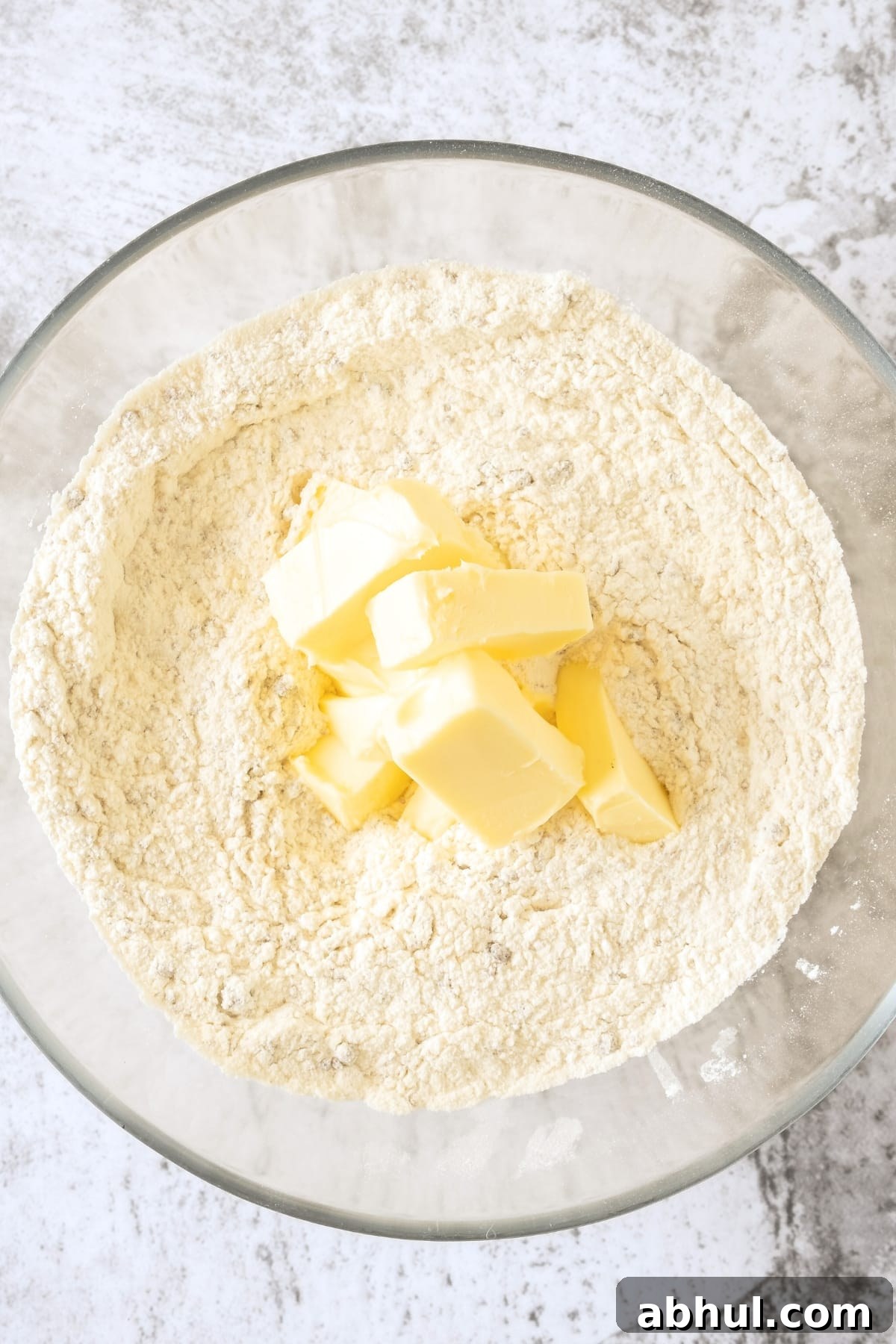 Cubed butter on top of flour mixture.