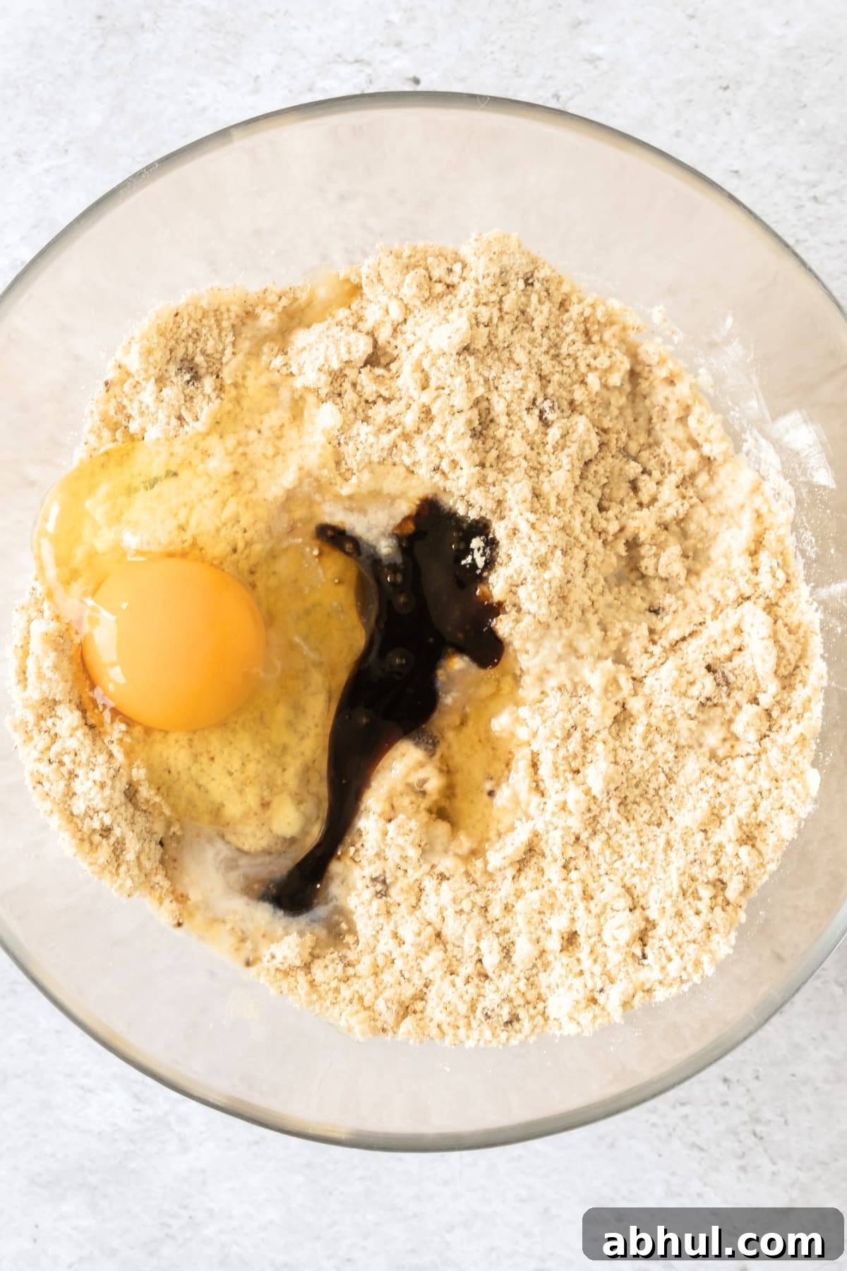 Egg and wet ingredients on flour mixture.