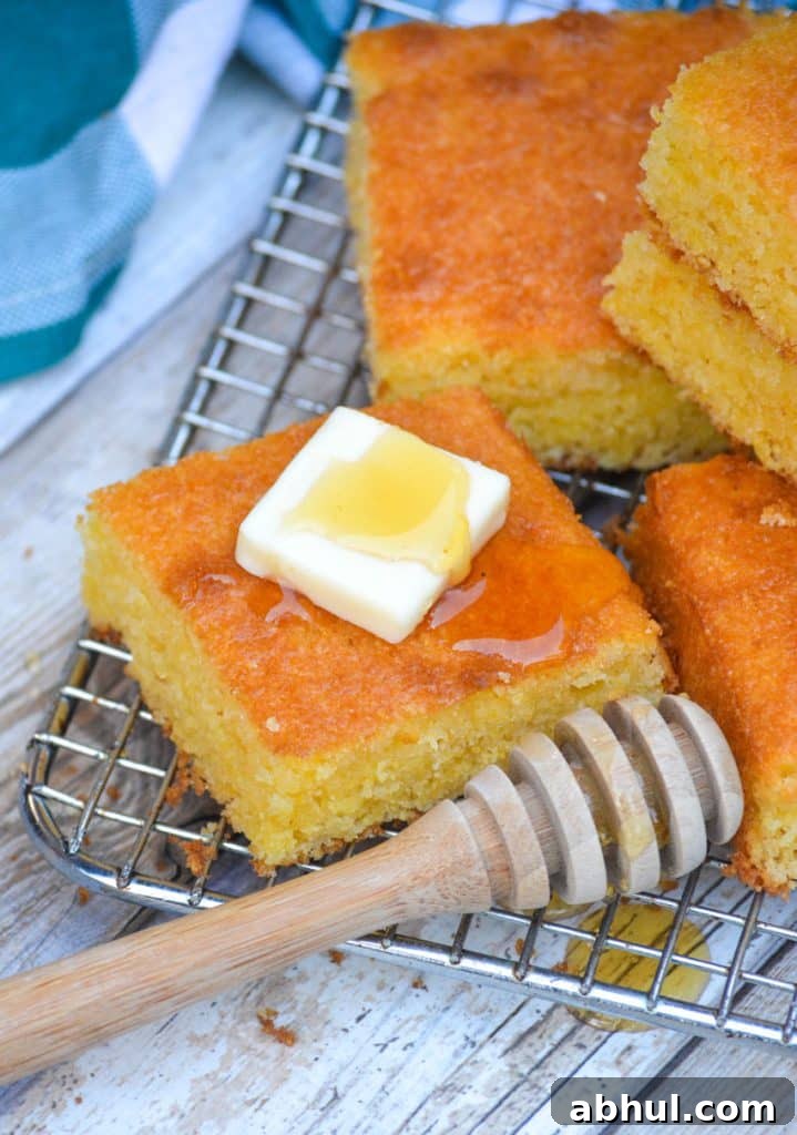 Make Moister Cornbread from a Box 2 a square piece of Southern style cornbread topped with a pat of butter and drizzle of honey