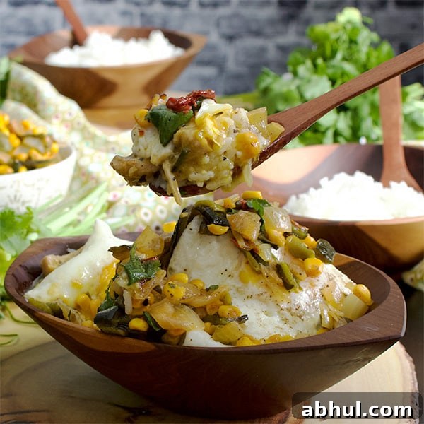 Taking a bite of Tomatillo Pulled Chicken and Rice Bowls with fried eggs and roasted corn salsa