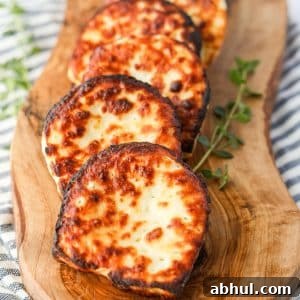 A wooden board with slices of halloumi cheese.