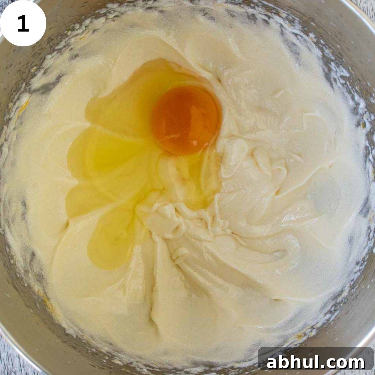 A egg cracked onto creamy butter mixture.