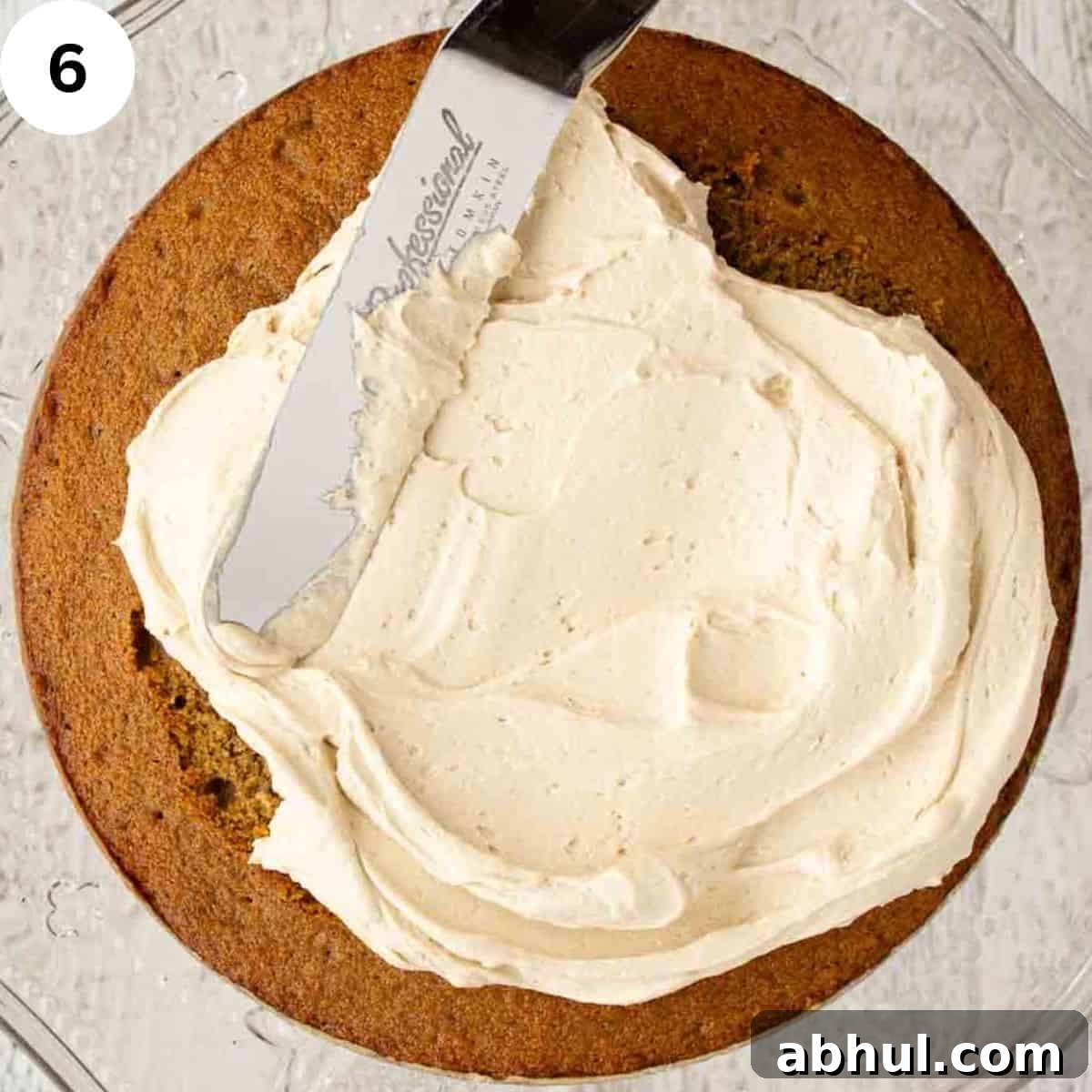 Buttercream being spread on a cake with a palette knife.