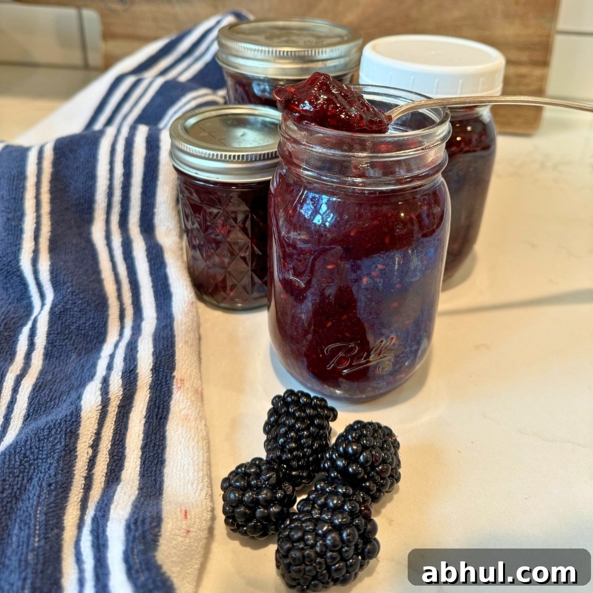 Low-Sugar No-Cook Blackberry Freezer Jam (No Pectin) 6 blackberry freezer jam in jar with spoonful