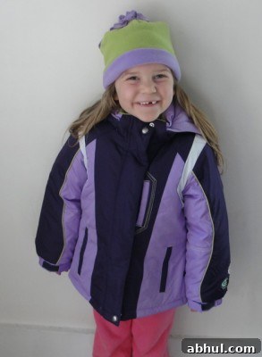 smiling happy girl wearing purple winter coat