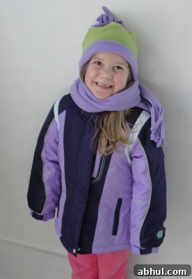 smiling happy girl wearing purple winter coat
