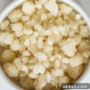 Homemade sugar pearls already dry in a white bowl.