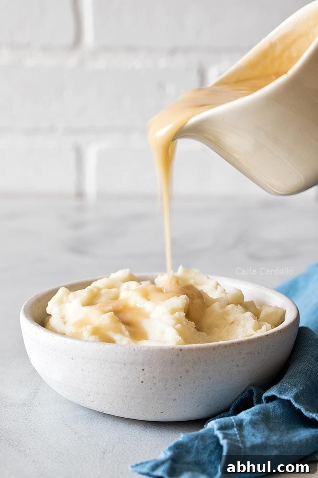 Pouring Gravy Over Mashed Potatoes