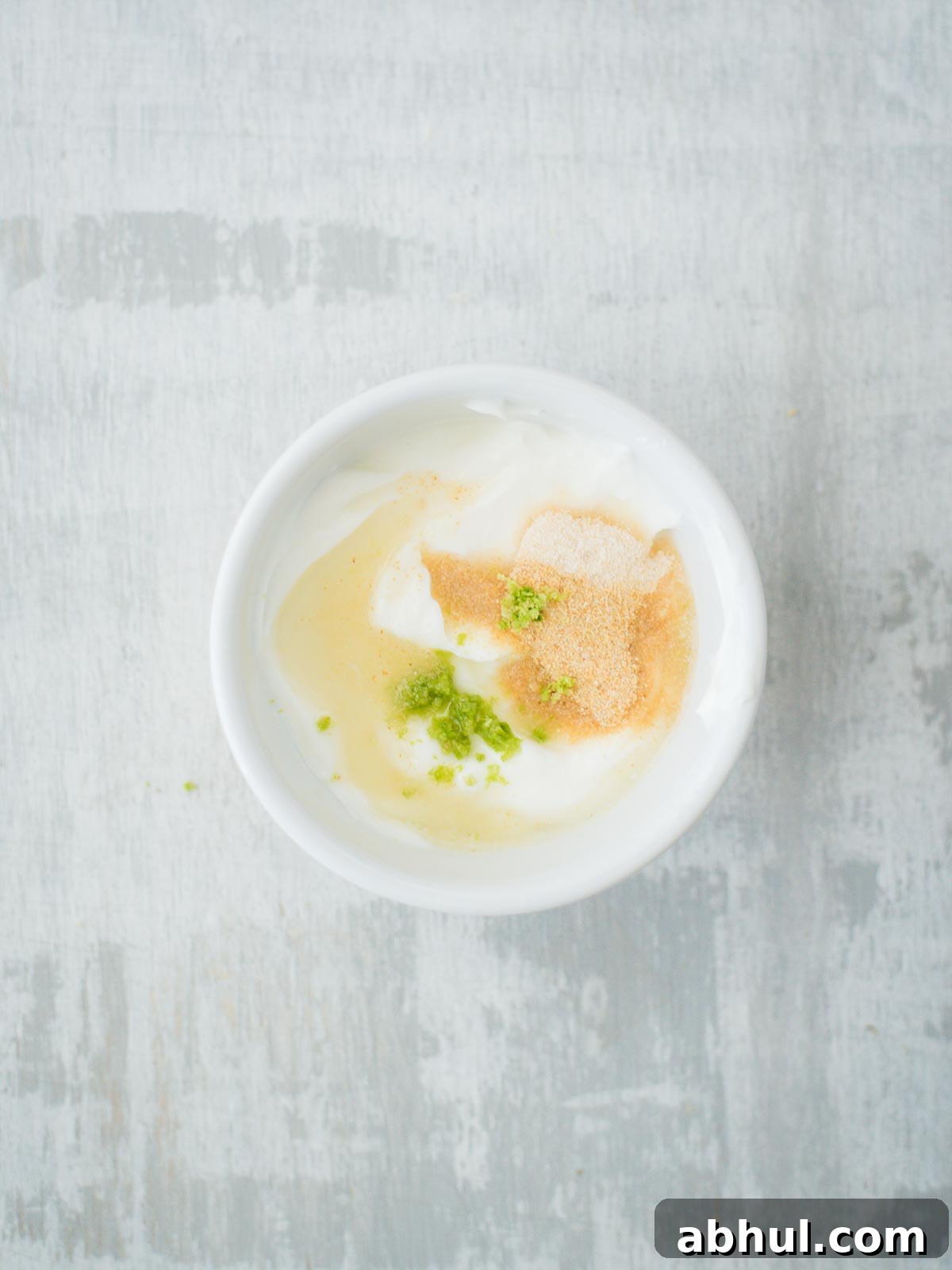 creamy lime sauce ingredients in bowl with lime juice