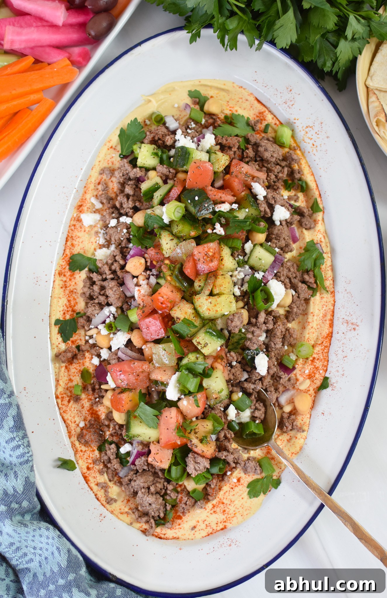 Ground Beef Layered Hummus with a spoon.