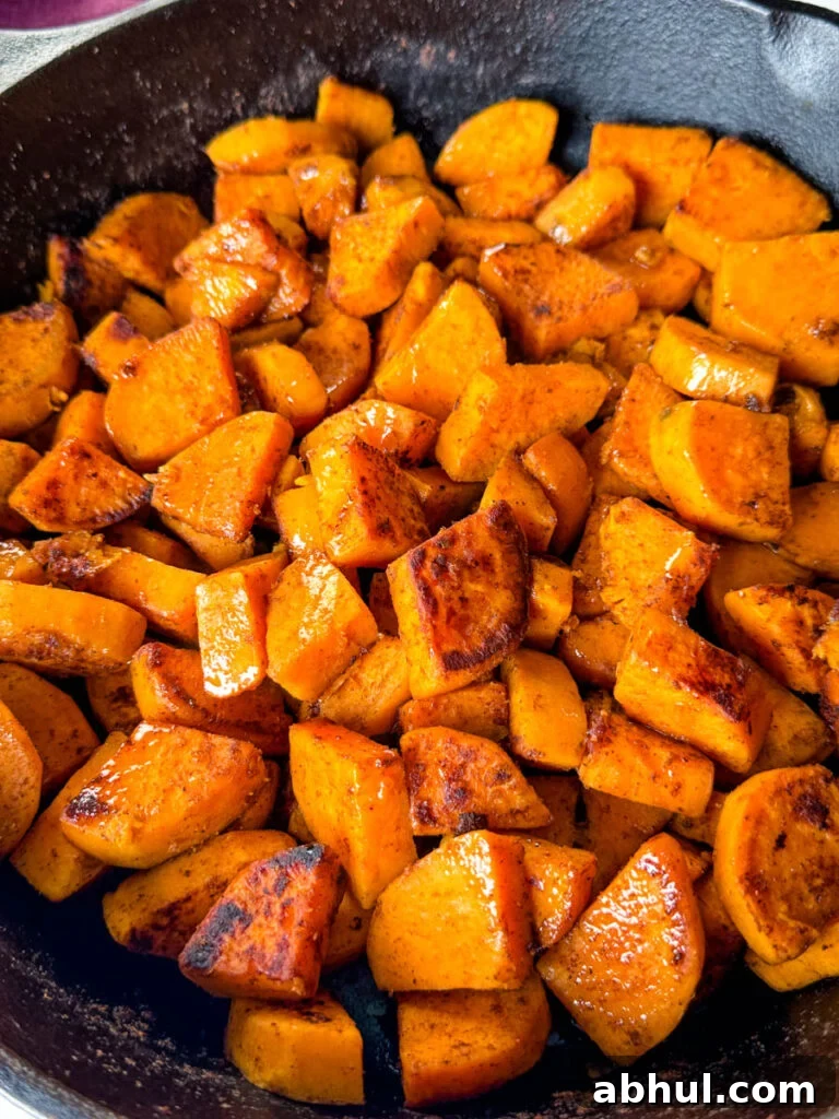 Crispy Fried Sweet Potatoes with Honey and Cinnamon 11 fried sweet potatoes in a cast iron skillet