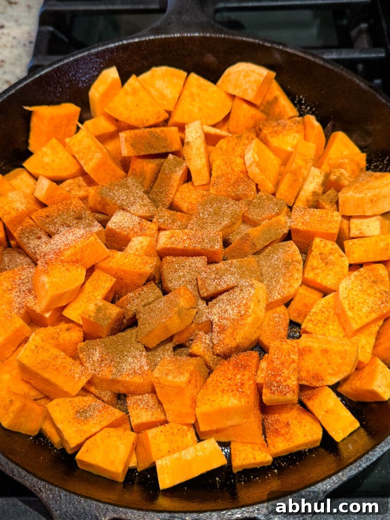 Crispy Fried Sweet Potatoes with Honey and Cinnamon 5 uncooked sweet potatoes in a cast iron skillet