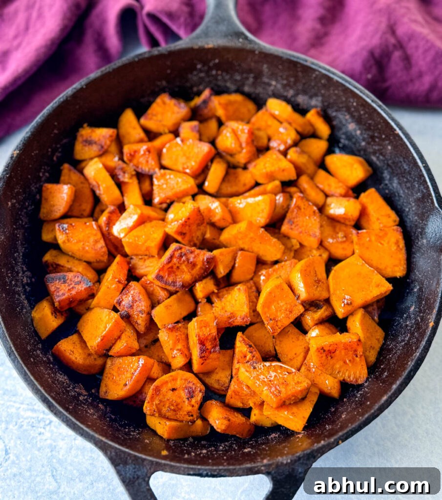 Crispy Fried Sweet Potatoes with Honey and Cinnamon 9 fried sweet potatoes in a cast iron skillet