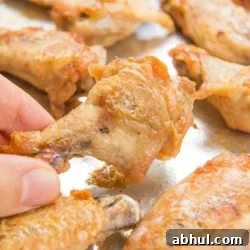 Baked Chicken Wings On a Sheet Pan with Close Up Showing Crispy Texture