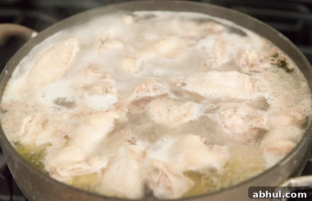 Parboiling the wings in water