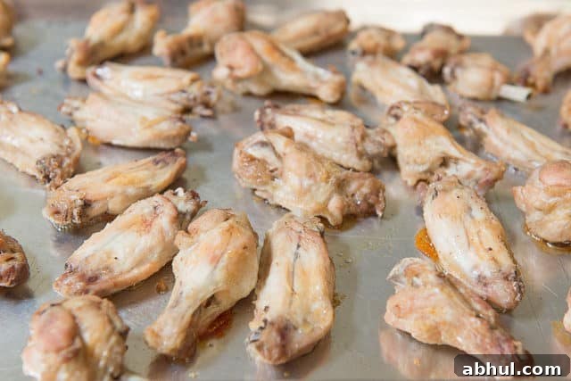 Partially Cooked Baked Wings on Sheet Pan