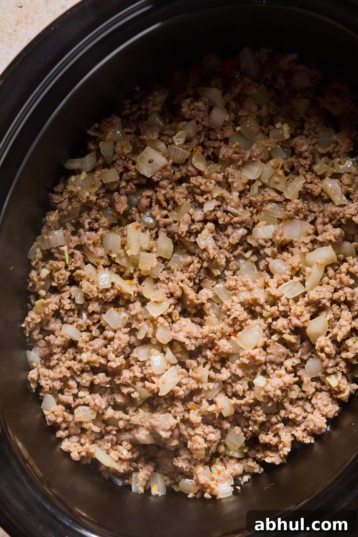 Italian sausage added to slow cooker.