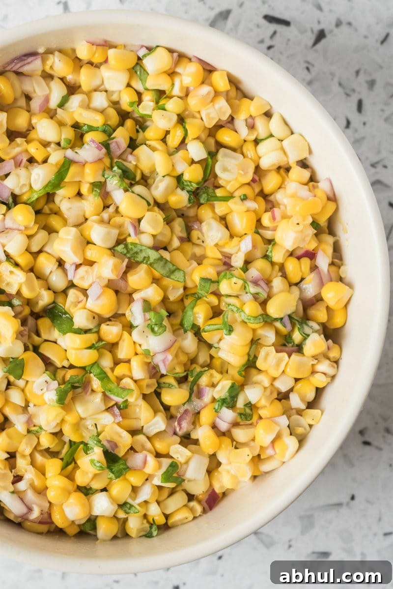 Fresh Corn Salad in a bowl overhead shot of fresh corn salad in a white bowl