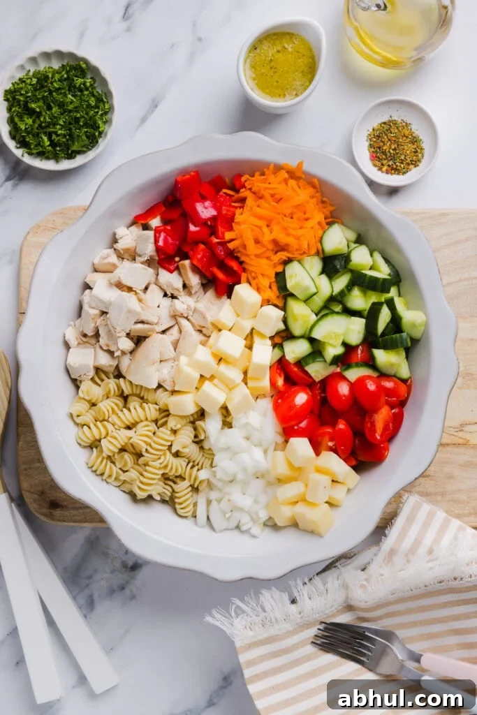 Ingredients for high protein pasta salad in a large bowl.