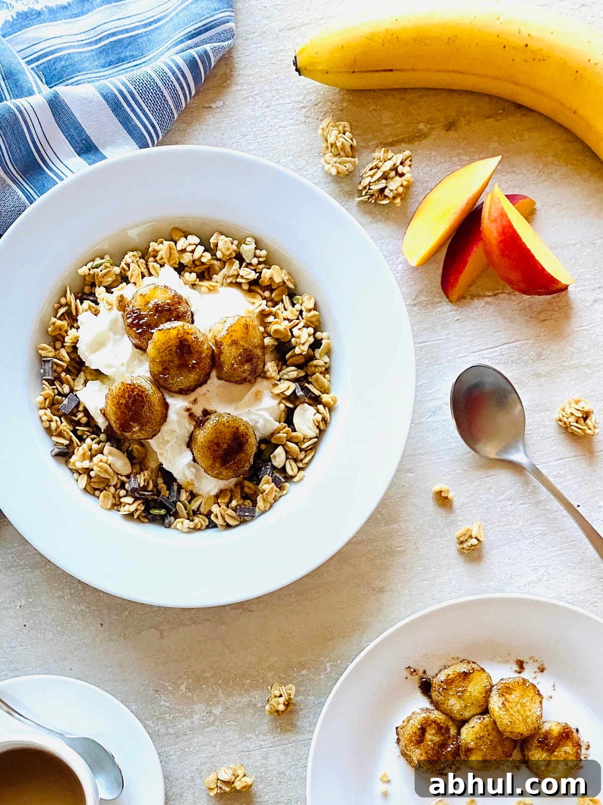 Crispy Caramelized Bananas in the Air Fryer 5 air fryer caramelized bananas in a bowl with yogurt and granola next to bananas and nectarines